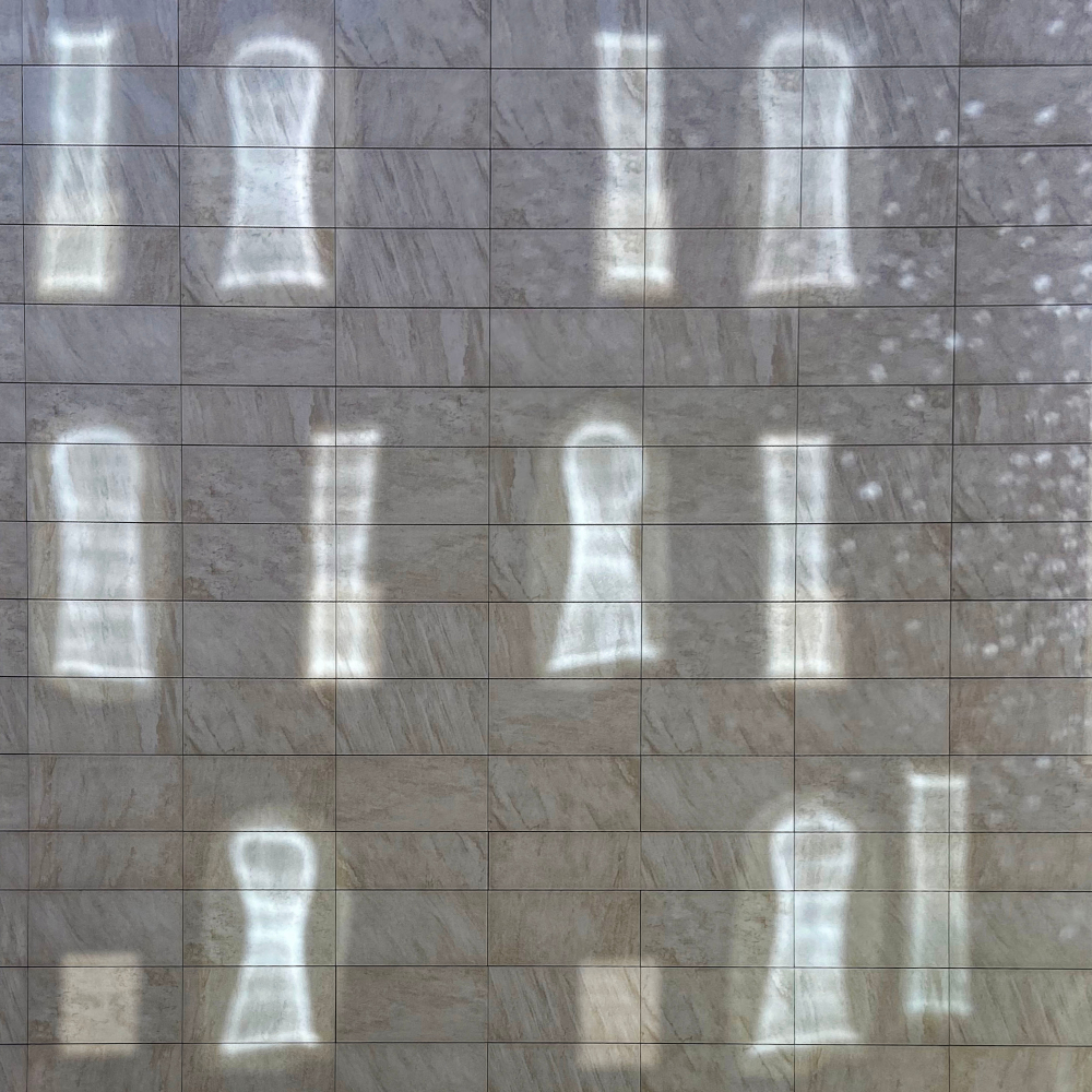 reflections of sunlit windows on a sheet covered building