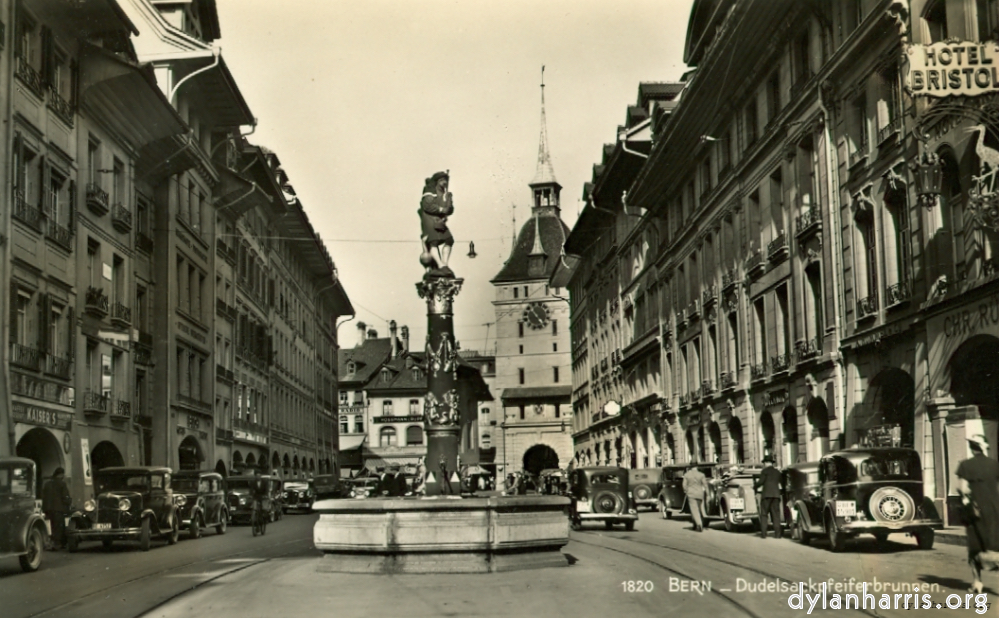 image: Postcard: 8120 Bern - Dudelsackpfeiferbrunnen. [[ Bagpipers Fountain 1540. Spetalgasse, Bern. Hotel Baren at left about half-way along. ]]